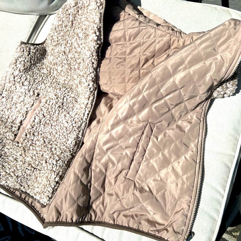 Reversible vest super comfortable also has hood and pockets in both sides
